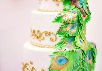pastel de bodas blanco con plumas de pavo real