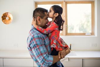 Hija besando a padre en casa